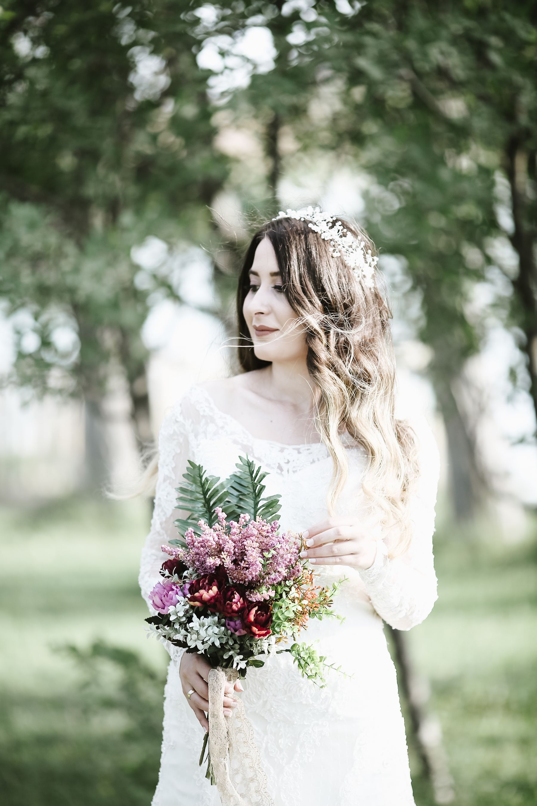 A bride holding her bouquet in the woods