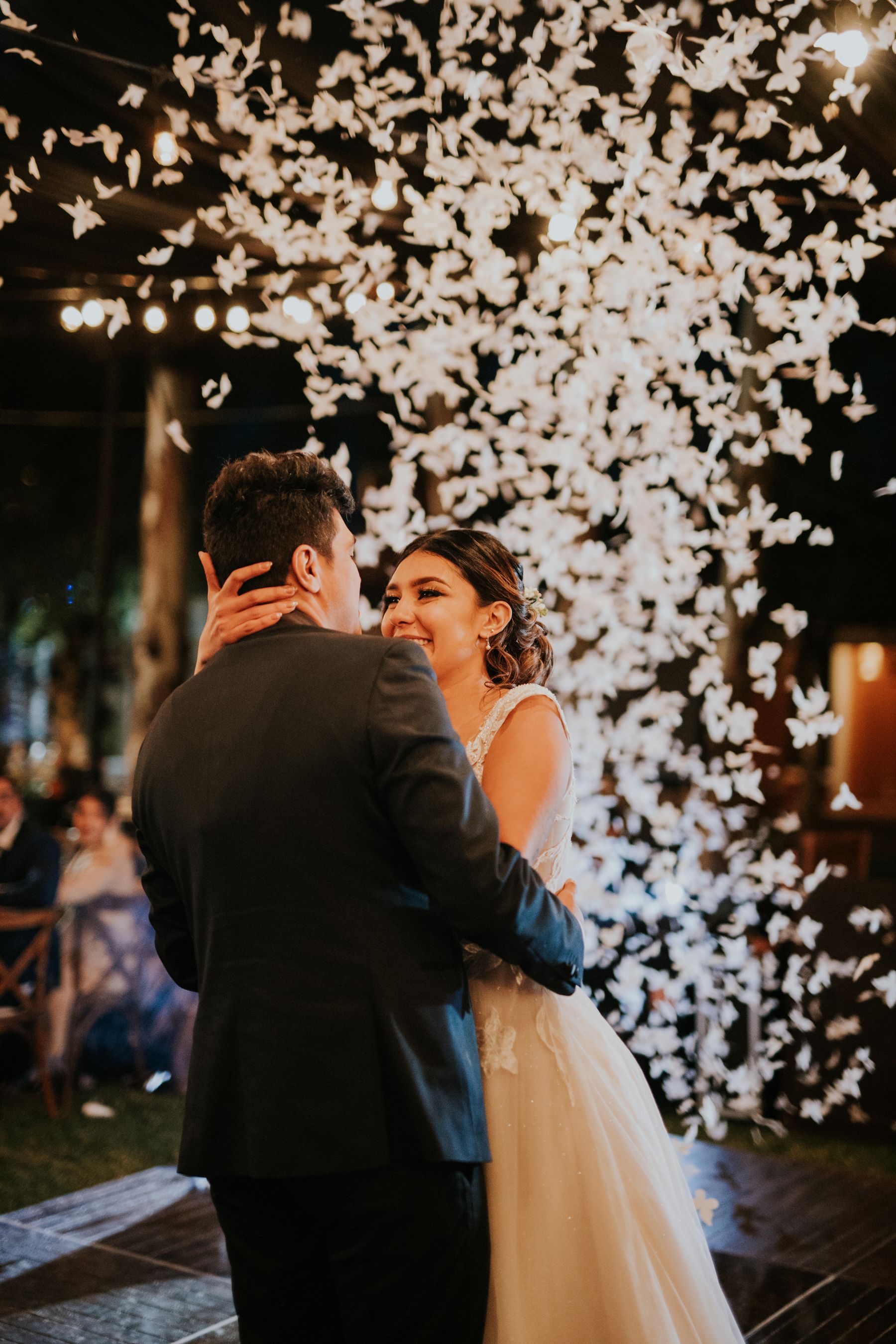The couple dancing under falling petals