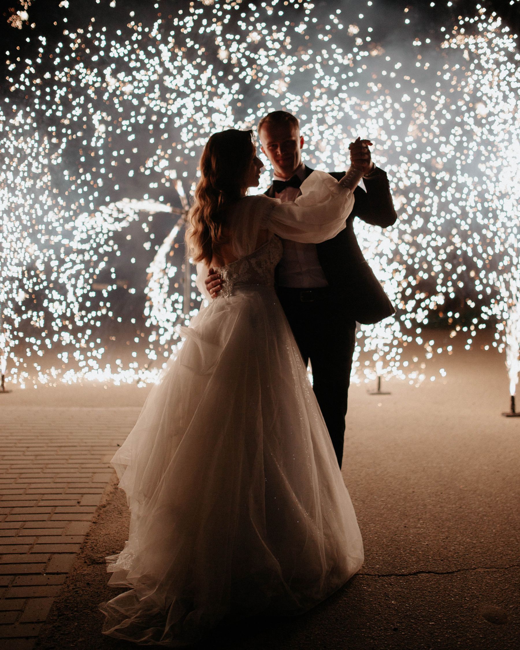 The couple dancing in a shower of sparks