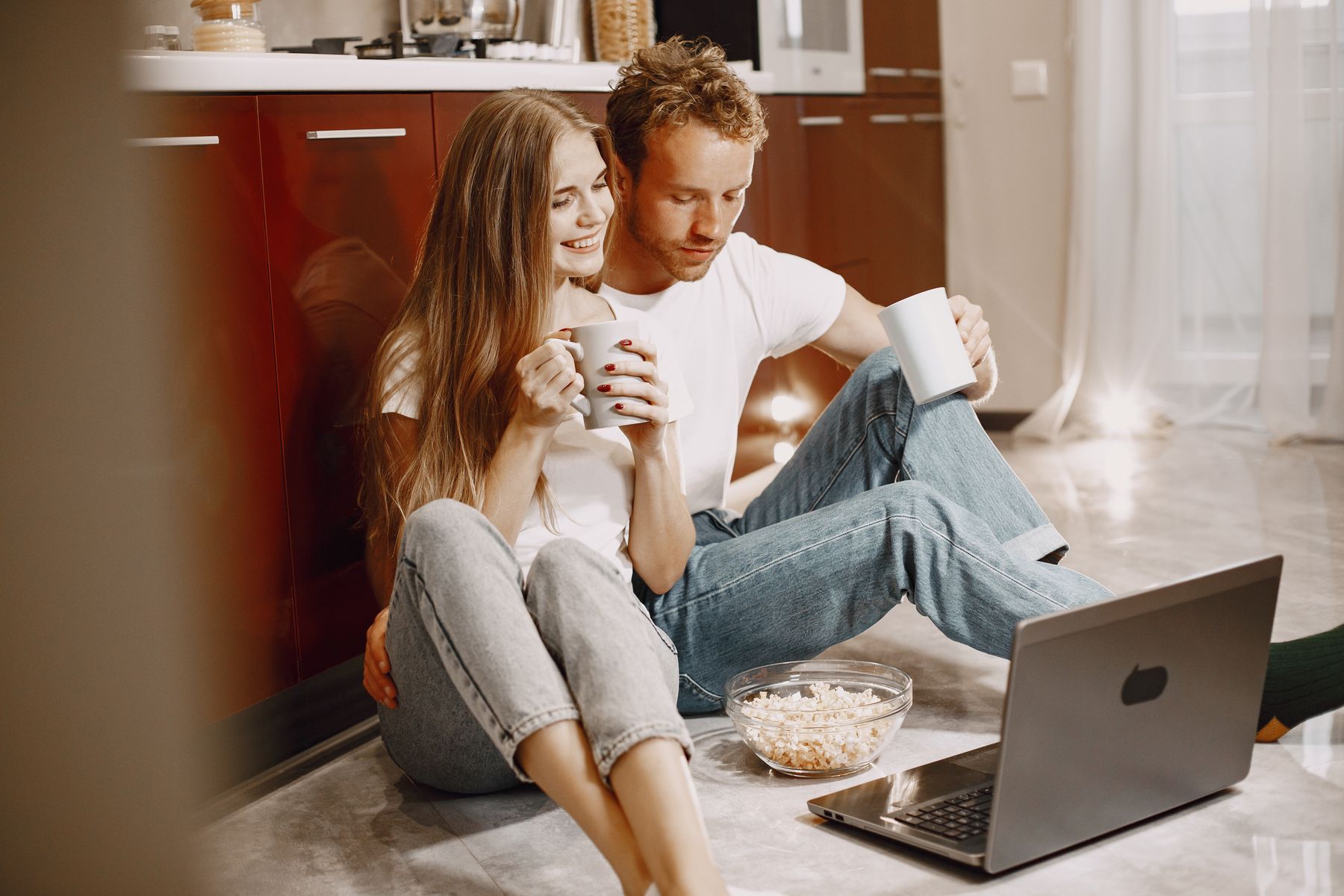 A couple watching their wedding film together